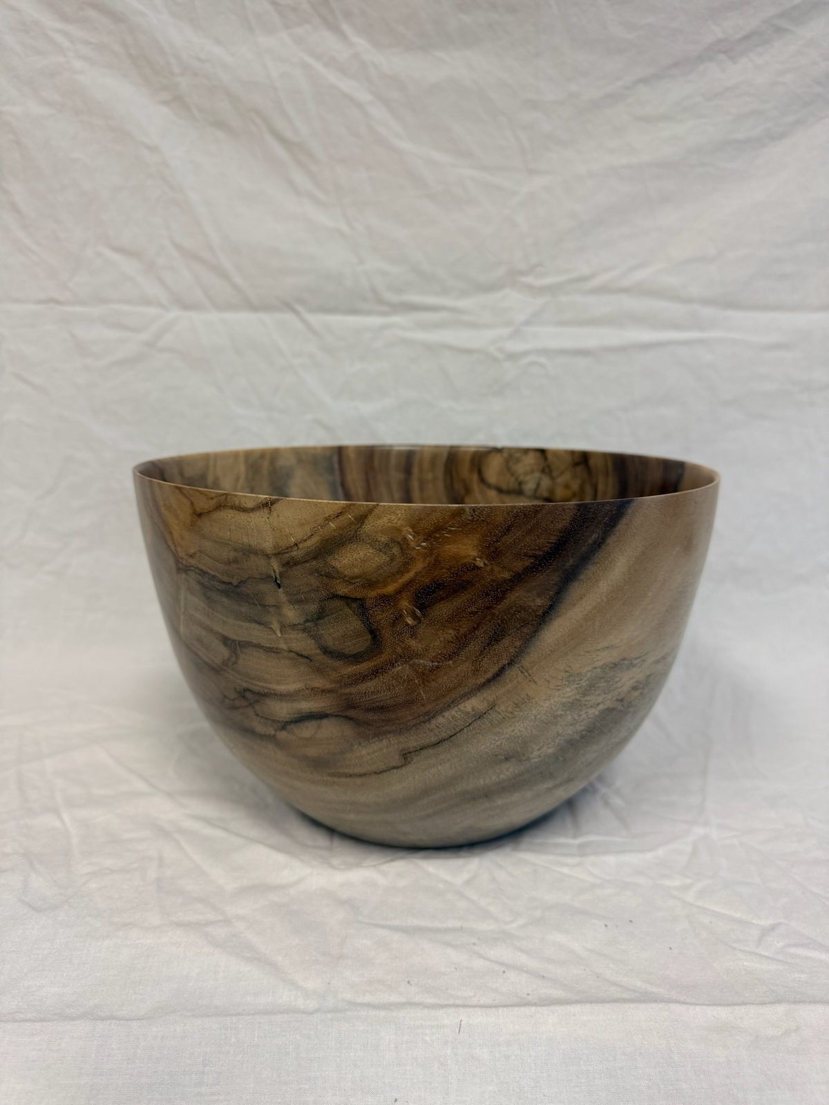 Hand-turned bowl in gray-brown wood with fine dark grain striping