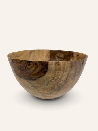 Hand-turned bowl in blonde wood with a reddish burl swirl