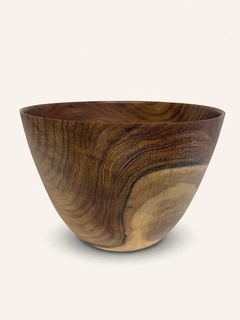 Hand-turned bowl in deep reddish-brown wood with a pale sapwood patch