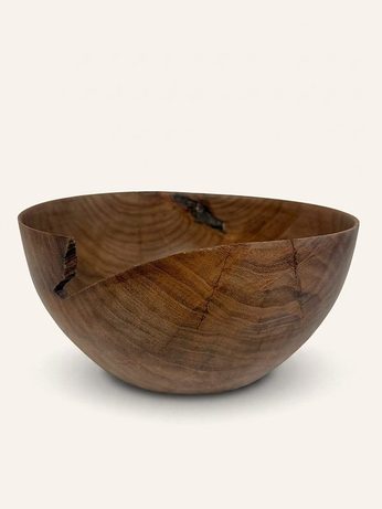 Hand-turned bowl with a natural bark-inclusion notch at the rim