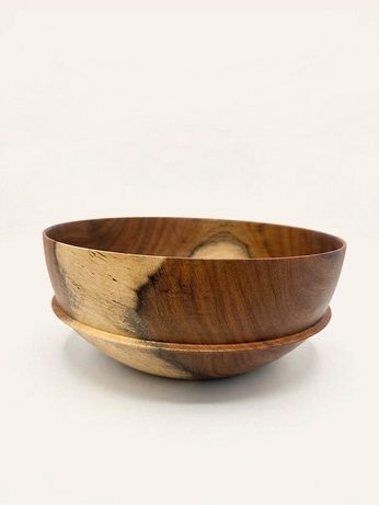 Hand-turned bowl on a footed base, in warm reddish-brown wood