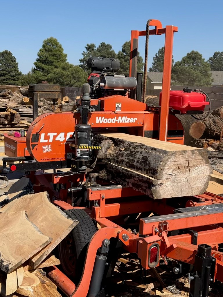 A log on the portable band sawmill