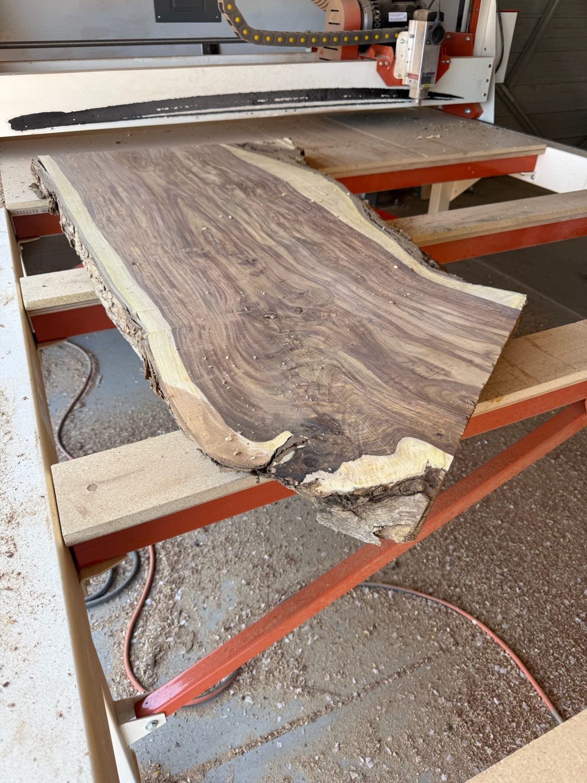 A live-edge Arizona walnut slab in the Scottsdale Edge Works studio